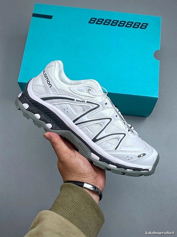 Salomon White and Gray Trail Runners Highlighting Treaded Trail Sole